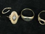 three rings and a ring on a black surface