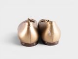 a close up of a pair of gold shoes on a white surface