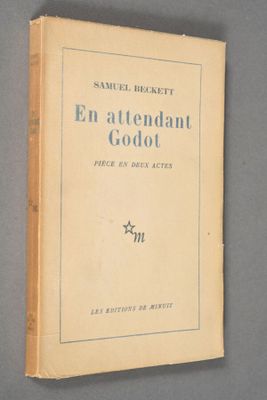 an old book sitting on top of a table next to a wall