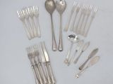 a lot of forks and spoons on the table