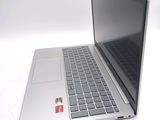 a silver laptop computer sitting on top of a white table