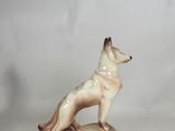 a figurine of a dog standing on a rock