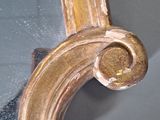 a mirror that has a gold frame on it