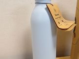 a water bottle sitting on a table next to a cardboard box