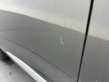 a close up of a car ' s side door with scratches on it