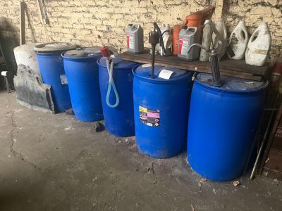 several blue barrels sitting next to each other in a room