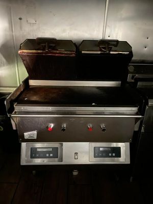 a picture of a grill with two burners on it