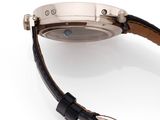 a close up of a watch on a white surface with a black strap
