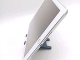 a tablet that is sitting on a stand on a table