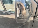 a reflection of a building in the side mirror of a car