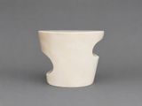 a white vase that is sitting on a table