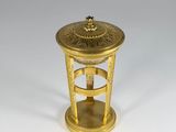 an old brass table with a clock on top of it