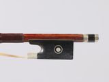 a violin bow with a wooden handle and a metal tip