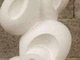 a sculpture made of white plastic balls on a table