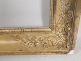 a picture of a gold frame on a white wall