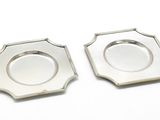 paire de dessous de verre plaqués argent sur fond blanc
