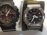 two watches that are sitting next to each other on a table