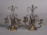 pair of antique brass candelabs with crystals on each of them