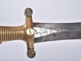 a person holding a very large knife in their hand