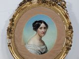 an old picture of a woman in a white dress in a gold frame