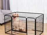 a dog is sitting in a black cage in a living room