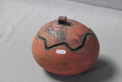 a small orange ball with writing on it on a table