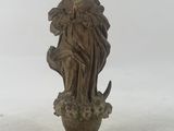 statue of a woman holding a bird on a pedestal