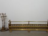 an image of a gold metal bench with a broom and a broom stand