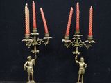 pair of antique brass candelabs with figurines and candles