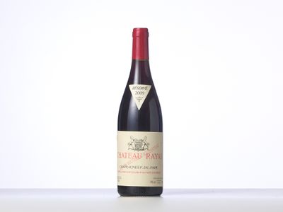 a bottle of red wine sitting on top of a table