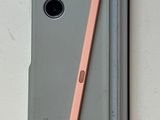 a gray case with a pink pen and a pencil on it