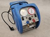 a blue air compressor with gauges and gauges on it