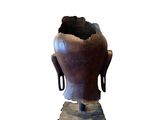 sculpture of a buddha head on a stand with a white background