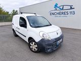 the small white van is parked in front of a building