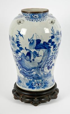 a blue and white vase with a bird on it