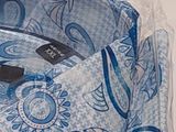 a close up of a shirt with a blue paisley pattern on it