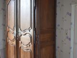a large wooden cabinet in the corner of a room