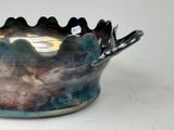 a bowl with spoons in it sitting on a table