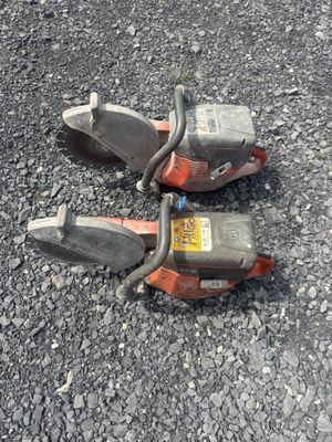 two chainsaws that are laying on the ground