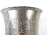 a silver vase sitting on a table with a white background