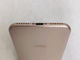 the back of a gold iphone 6g with a camera on top of it