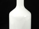 a white vase that is sitting on a table