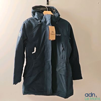 the jacket is hanging on a hanger on the wall