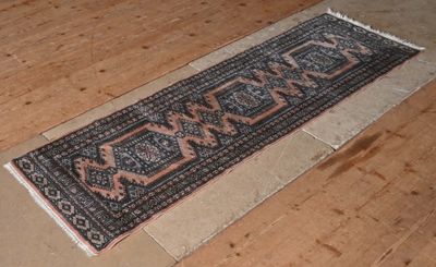 a long rug on the floor on the wooden floor