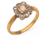 a close up of a gold ring with a white stone in the center