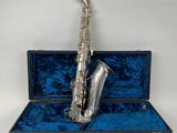a silver plated saxophone with a blue velvet case and silver keys