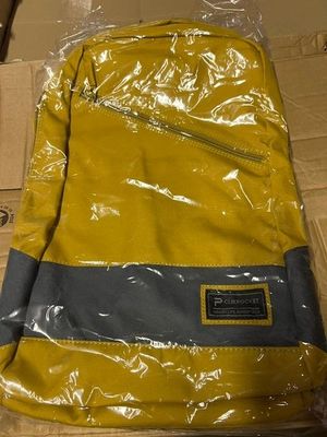 a yellow backpack that is sitting on a box