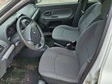 the interior of a car with the door open and the driver ' s seat down