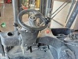 a close up of the steering of a tractor in a garage