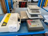 many different types of weighing on a table in a warehouse